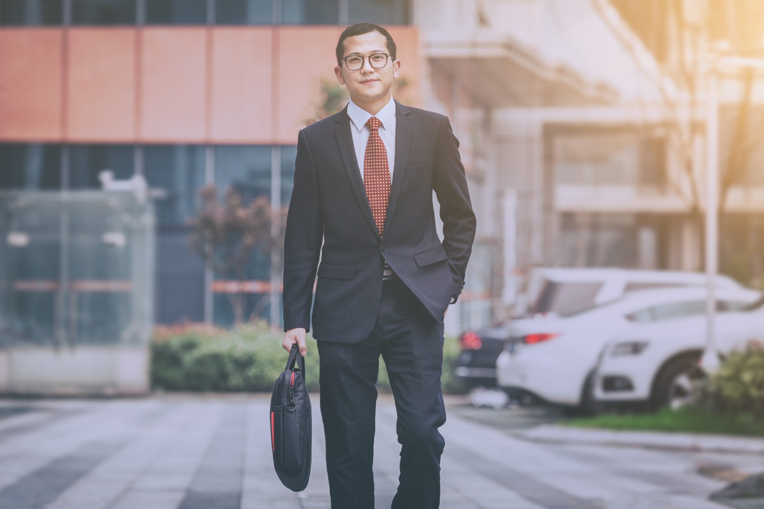 young businessman walking outside office